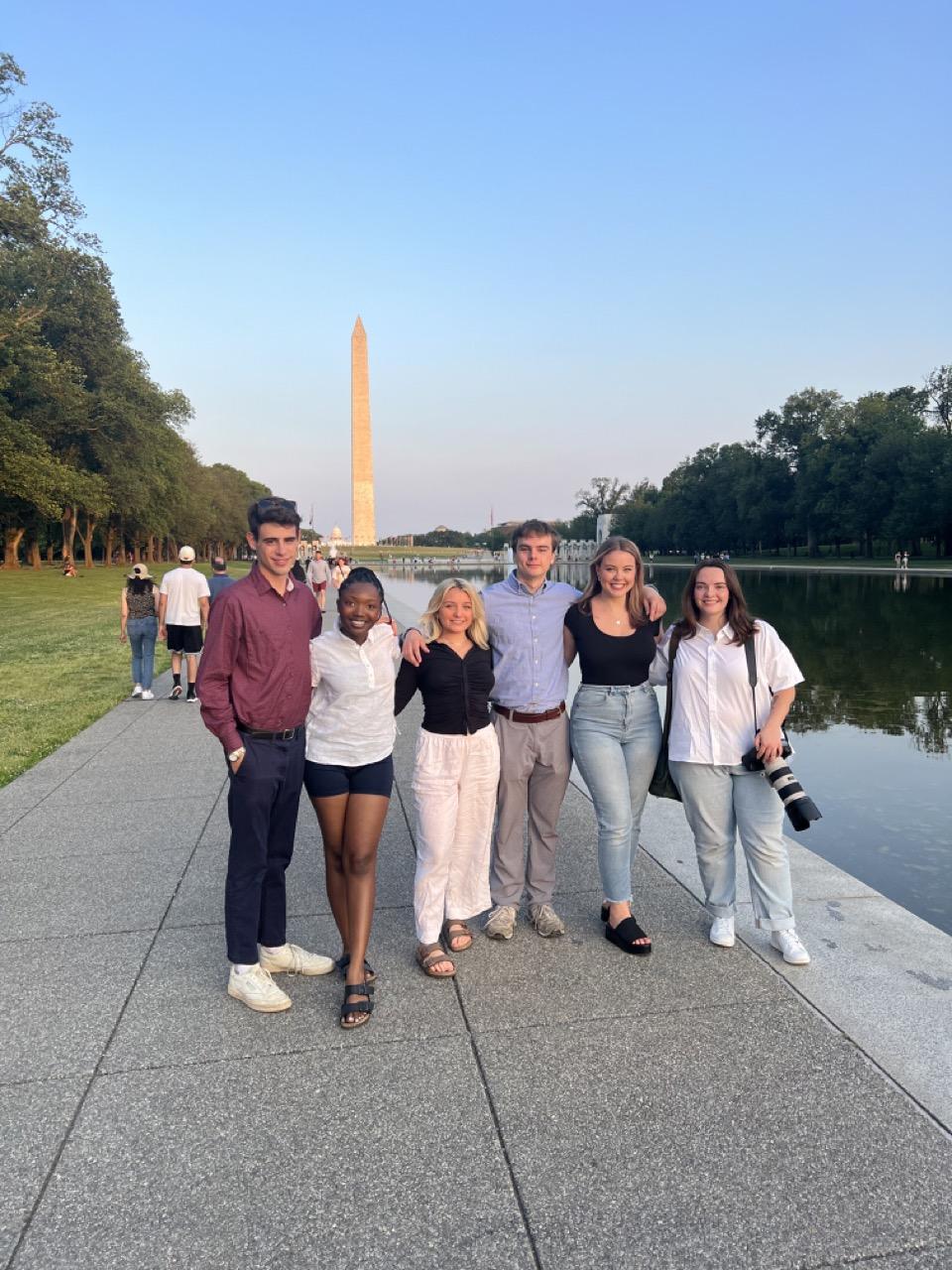 A group of students from the 2023 Summer Scripps in DC cohort poses in front of the Washington Monument.