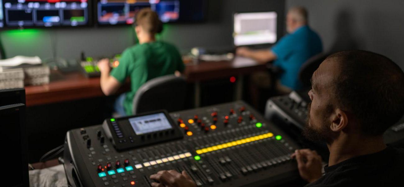 Students using equipment in electronic media studio