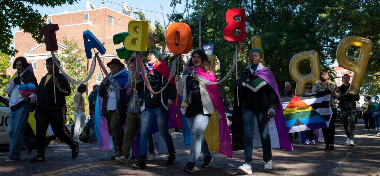 Students walk in homecoming parade in support of lgbtqia