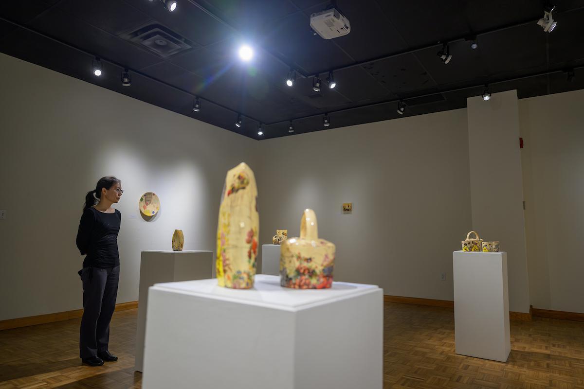 woman viewing pottery