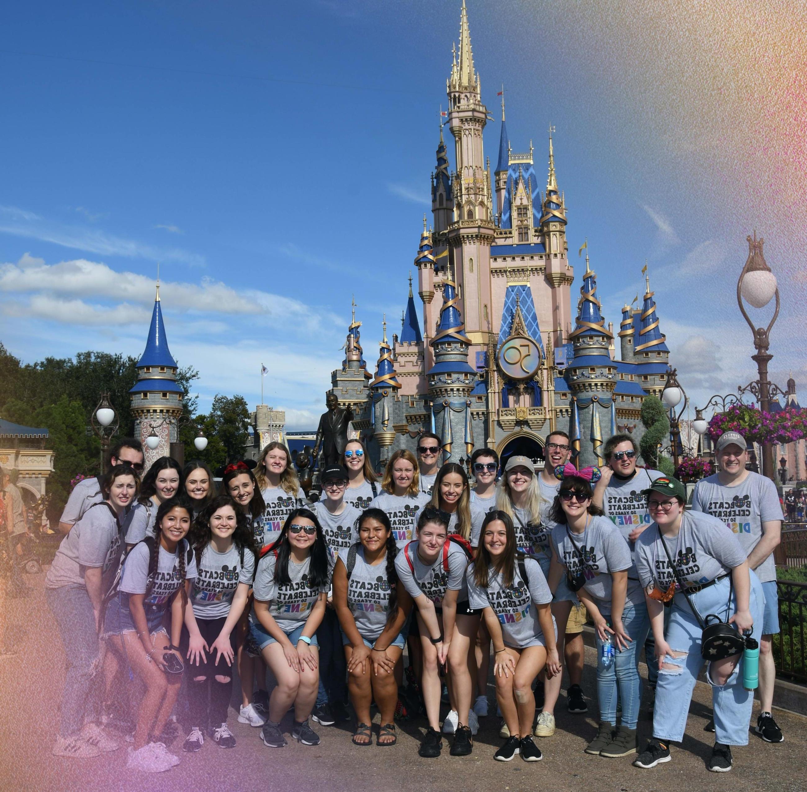 Group of students in front of the Disney castle. 